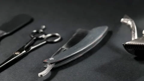 On a black surface are old barber tools. Vintage Stock Footage 143175909