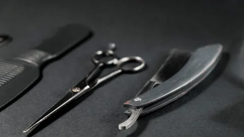 On a black surface are old barber tools. Vintage Stock Footage 143176105
