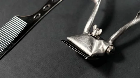 On a black surface are old barber tools. Vintage Stock Footage 143176470