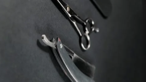 On a black surface are old barber tools. Vintage manual hair clipper, comb, razo Video stock 143177028