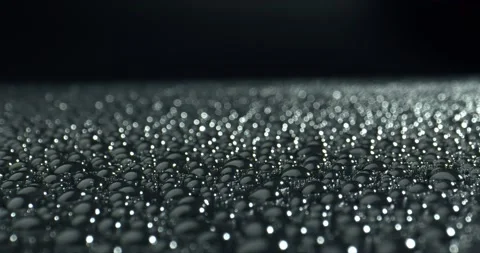 Black surface in drops of water. Light reflection in the drops. Stock Footage 143171232
