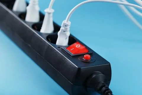 Black surge protector with a red button and connected white wires of electr.. Stock Photos