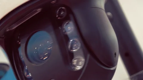 Black surveillance camera rotates for checking the surrounding area Video stock 64736362