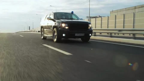 A black SUV is driving. Video stock 166214395