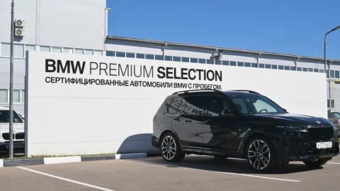A black SUV is parked in front of the BMW Premium Selection dealership, Видео 344673091