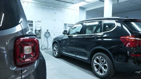Black SUV Parked Inside a Modern Car Paint Booth Stock Footage 318309058
