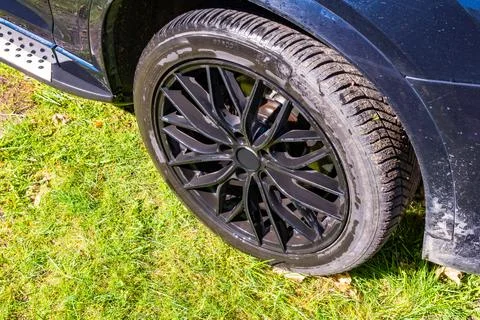 Black SUV Wheel on Grass Stock Photos