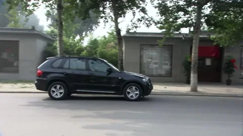 Black suvs coming to stop Stock Footage 235276696