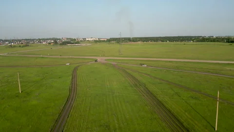 Black suvs crossing rural intersection, aerial view capturing countryside road Stock Footage 316179642