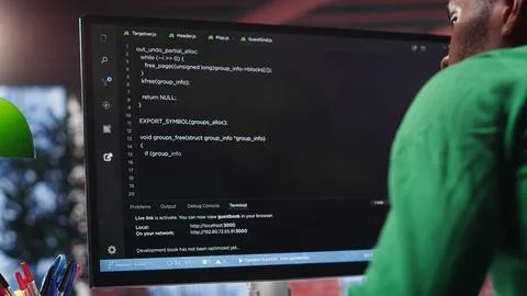Black system administrator creating a software with programming language Stock Photos