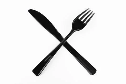 Black table fork and knife crossed on white background 写真素材