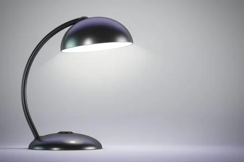 The black table lamp is on. Light background. Copy space. 스톡 사진