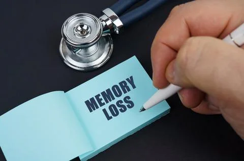 On a black table is a stethoscope and a notebook in which the man wrote - MEM Stock Photos