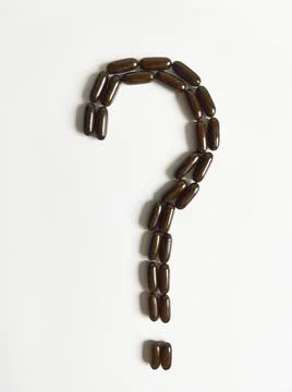 Black tablets in the form of a question mark top view Stock Photos