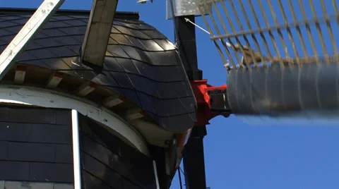 Black tarred windmill  - close up cap and windshaft, wicks turning Stock Footage 34531397