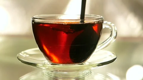 In Black tea is added the sugar and mix by teaspoon, slow motion  Stock Footage 57751489
