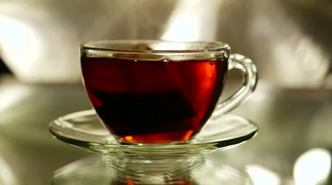 Black tea in a bag brewed with boiling water in cup and saucer Stock Footage 57750321
