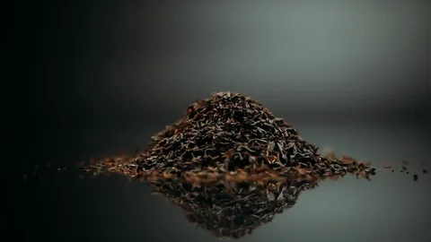 Black tea on a beautiful silver background rotates Stock Footage 98856719