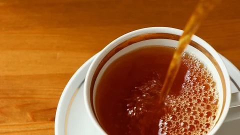 Black tea being poured into tea cup Stock Footage 88654655