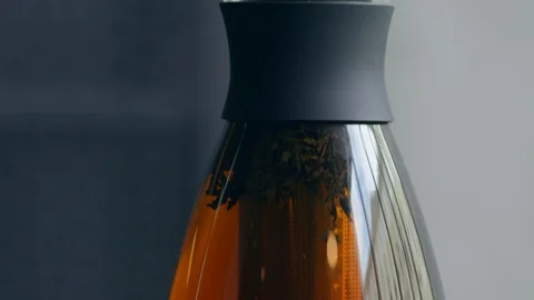 Black tea brewed tea in a glass teapot Stock Footage 129580360