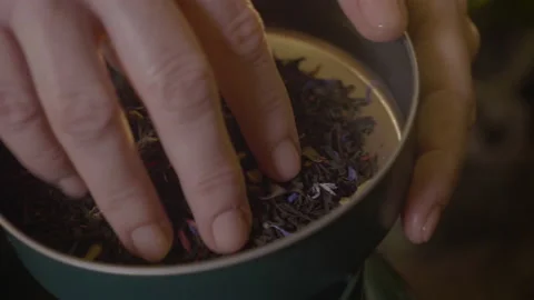 Black tea in a container is hand-touched 스톡 동영상 176466805