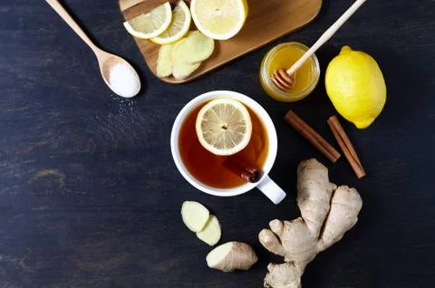 Black tea with ginger lemon and honey on dark background. Top view. Healthy Stock Photos