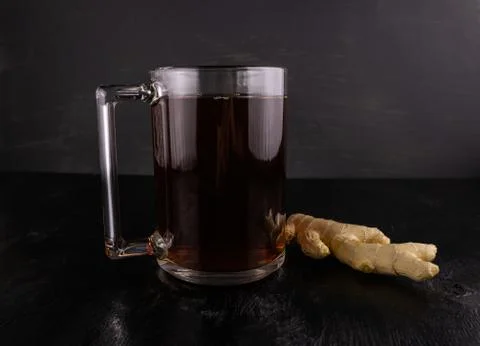 Black tea with ginger root Stock Photos