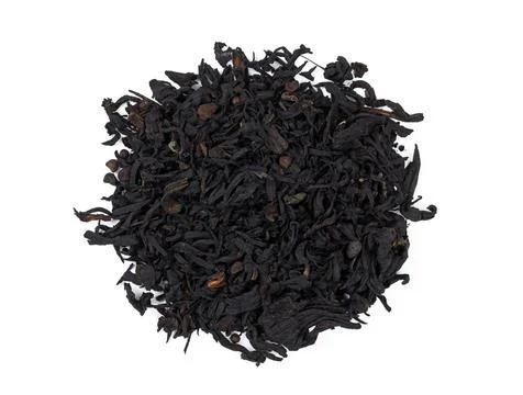 Black tea large-leaf dry on a white background. Stock Photos
