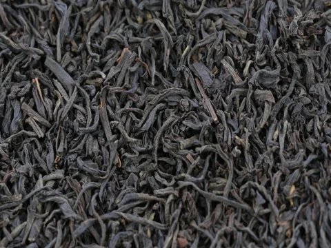 Black tea leaves close up. Loop rotation. Front of the camera rotates black tea Stock Footage 77764931