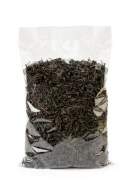 Black tea leaves in a package on a white, isolated. Stock Photos