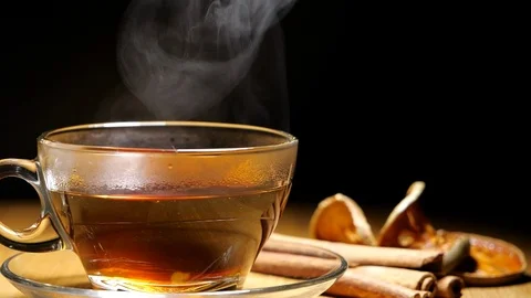 Black tea or hot herb drink in a cup with steam in slow motion Stock-Footage 114689668