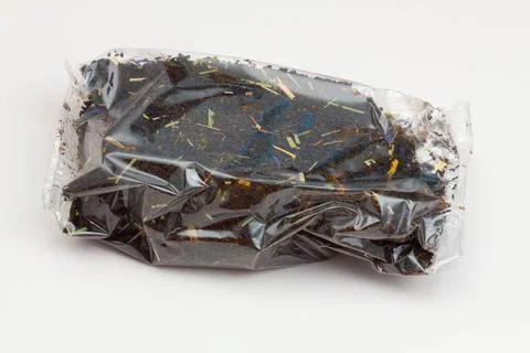 Black tea packaging on a white background. Long leaf tea with rose hips, apples Stock Photos