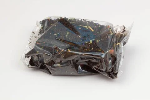 Black tea packaging on a white background. Long leaf tea with rose hips, apples Stock Photos