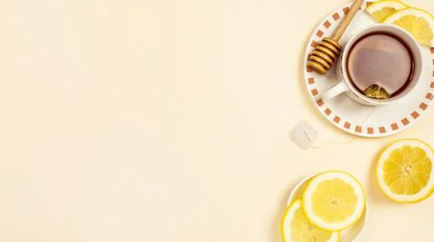 Black tea with slice fresh lemon beige background. High quality photo Stock Photos
