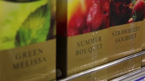 Black tea with strawberries, close-up, grocery store Stock Footage 75476735