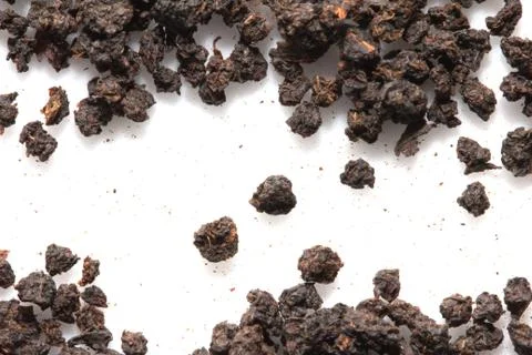 Black tea on a white background. macro Stock Photos