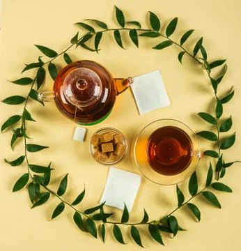 Black tea on a yellow background. Stock Photos