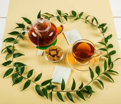 Black tea on a yellow background. Stock Photos