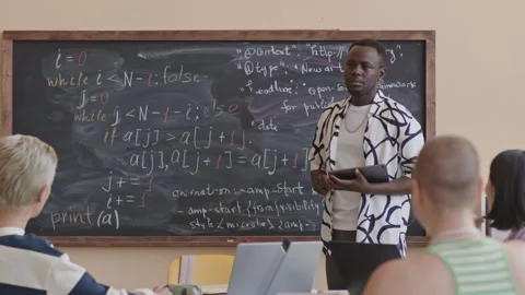Black Teacher Speaking with Students on Programming Class Stock Footage 257067102