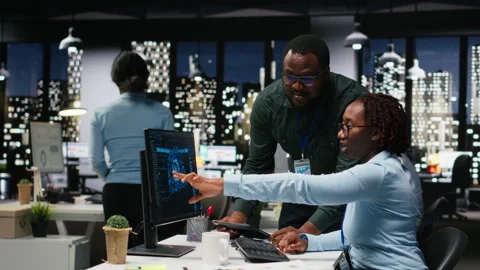 Black team of colleagues use artificial intelligence and predictive analytics Stock Footage 318564714