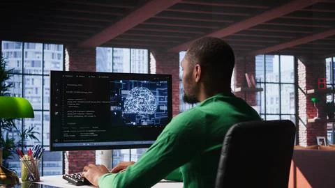 Black tech engineer programming an AI brain neural network for machine learning Stock Photos