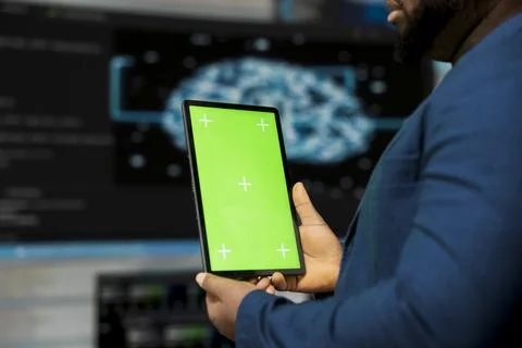 Black tech savvy programmer uses chroma key screen from innovation hub Stock Photos