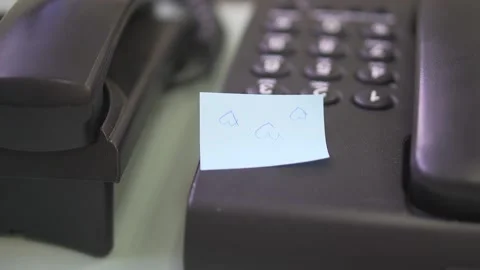 Black Telephone with blue paper note. Stock Footage 137685539