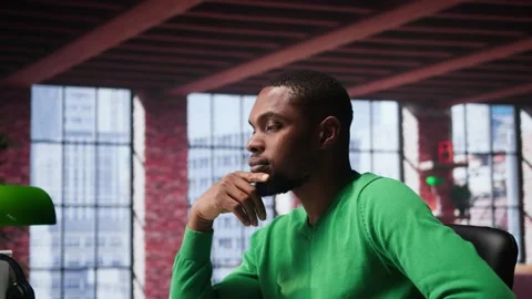 Black teleworker being pensive thinking about solutions to make more money Stock Footage 309119137