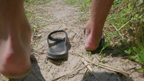 Black Textured Rubber Sandals Left Sitting on Dirt Footpath Outdoors Stock-Footage 342765930