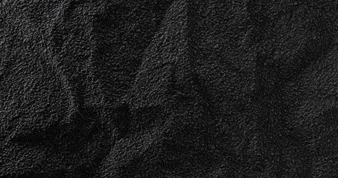 Black textured surface with shifting shadows and rough detail Stock Footage 344968249