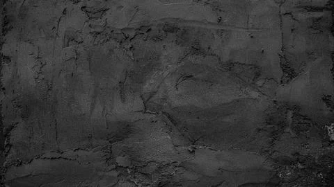 Black textured wall surface featuring intricate patterns and a rough grainy Stock Photos