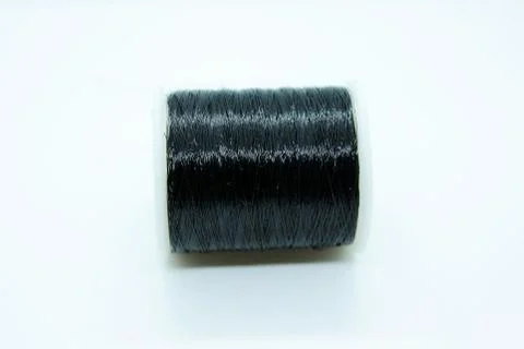The black thread coil is located on a white background Stock Photos