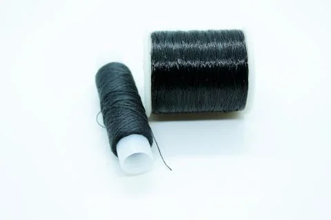The black thread coil is located on a white background Stock Photos