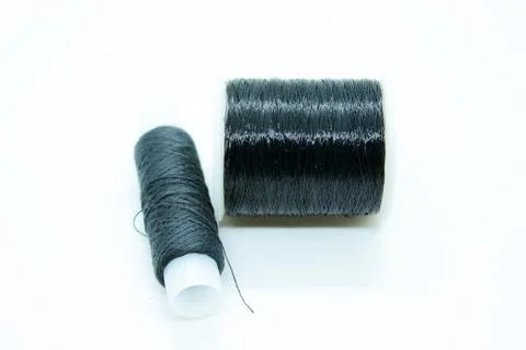 The black thread coil is located on a white background Stock Photos